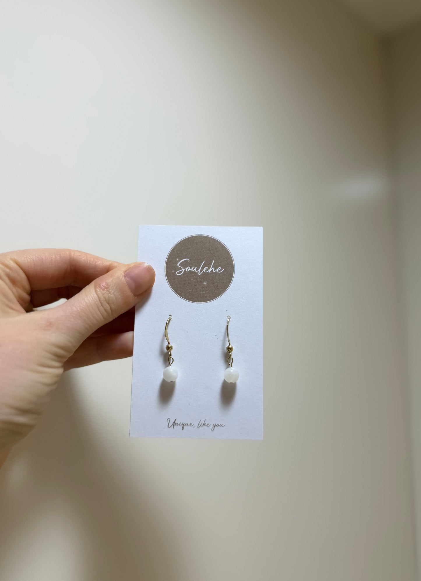 Gold earrings with Moonstone gemstones.