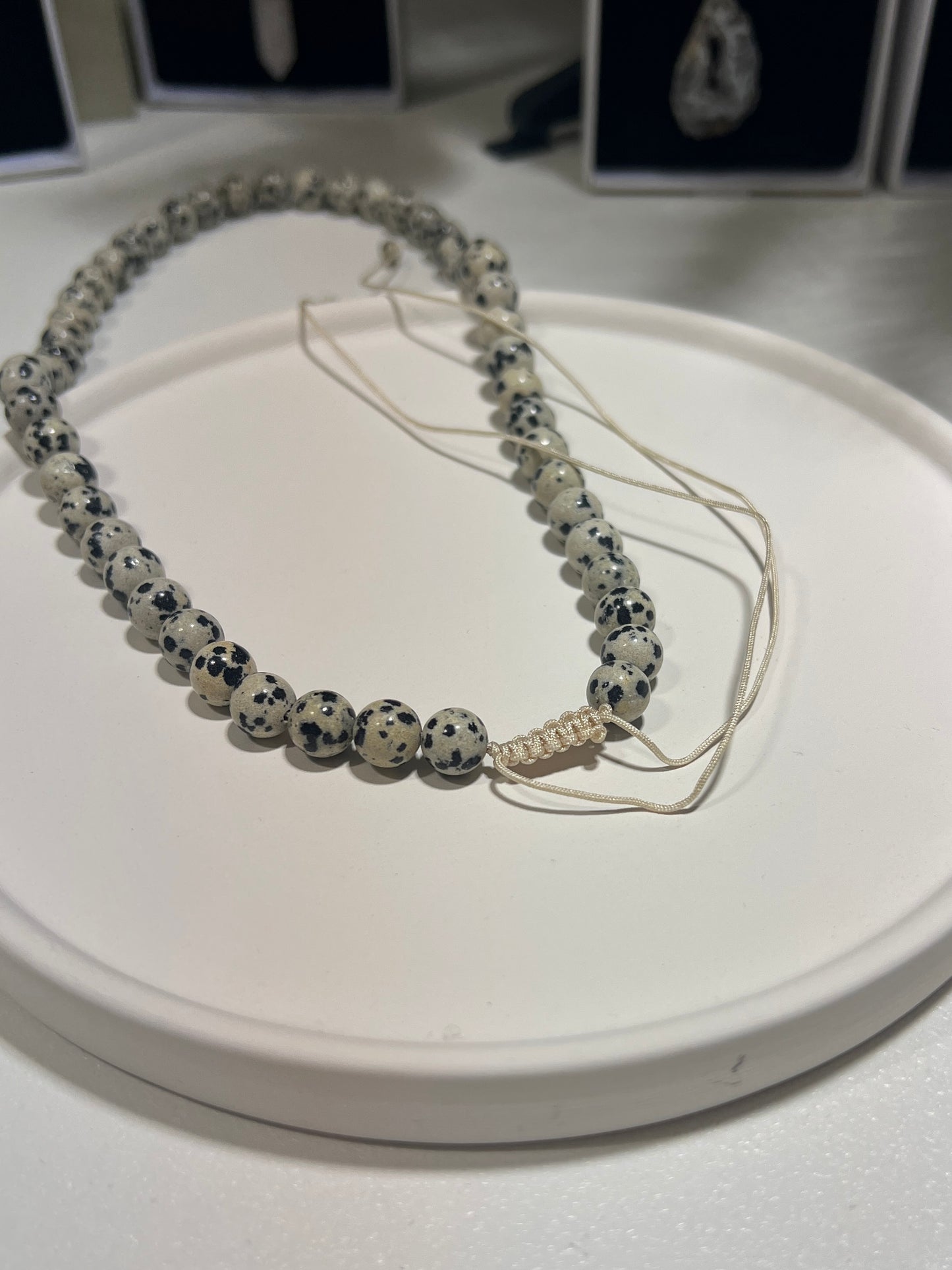 Necklace with dalmatian Jasper beads on a white surface