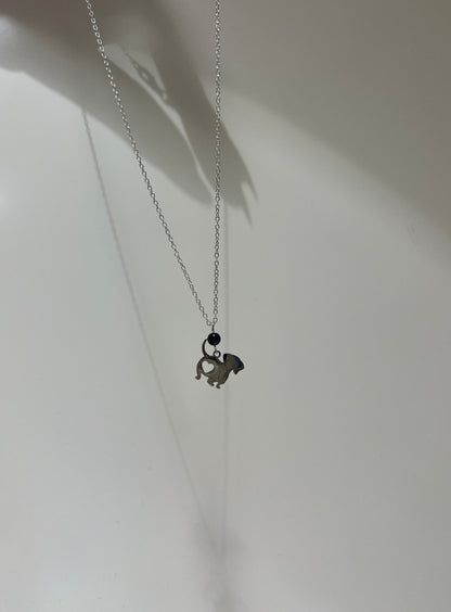 Necklace with a small pendant on a plain background