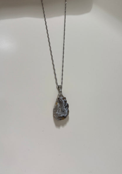 Silver necklace with a pendant on a white background