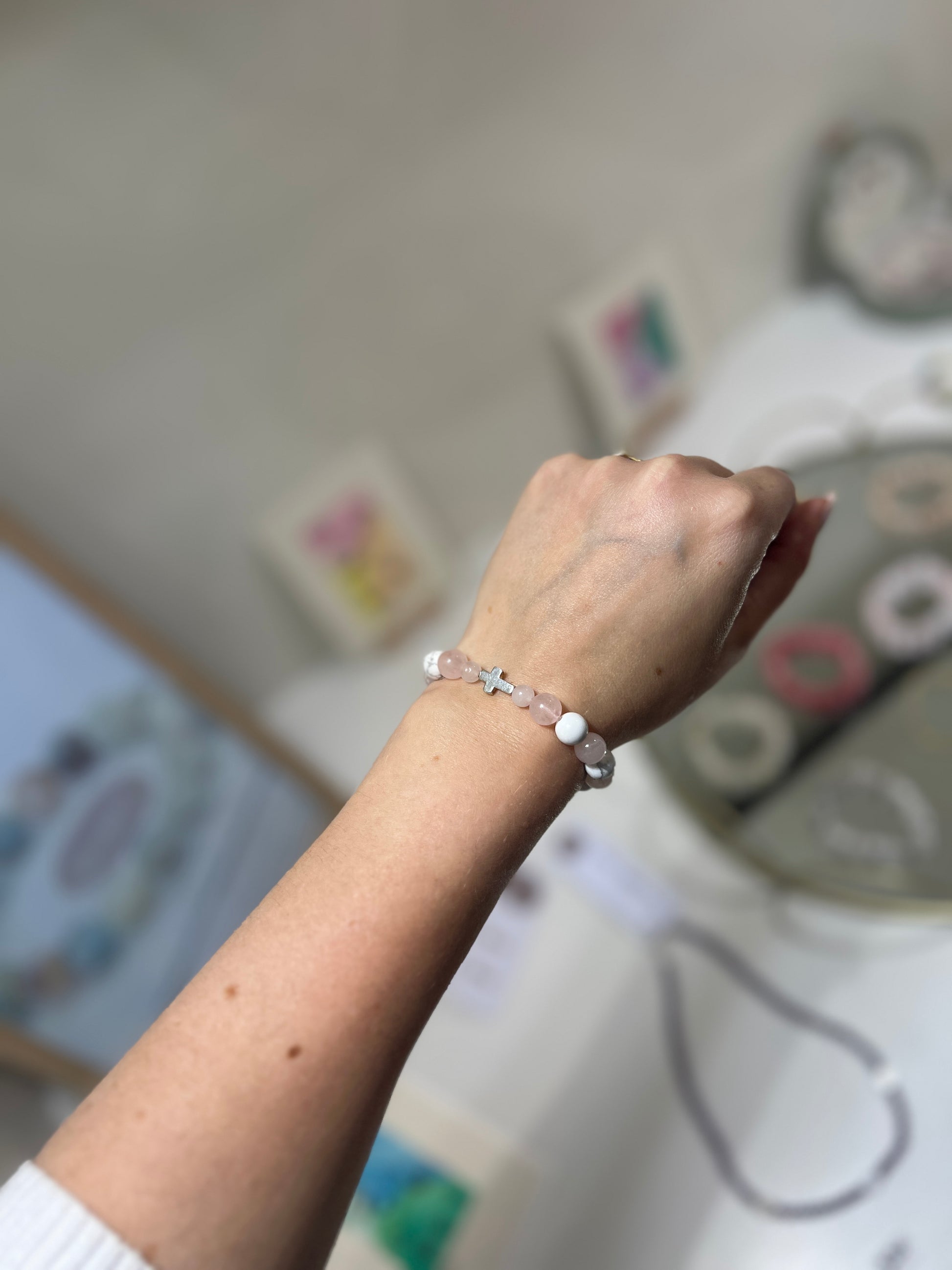 Hand wearing a bracelet with a blurred background