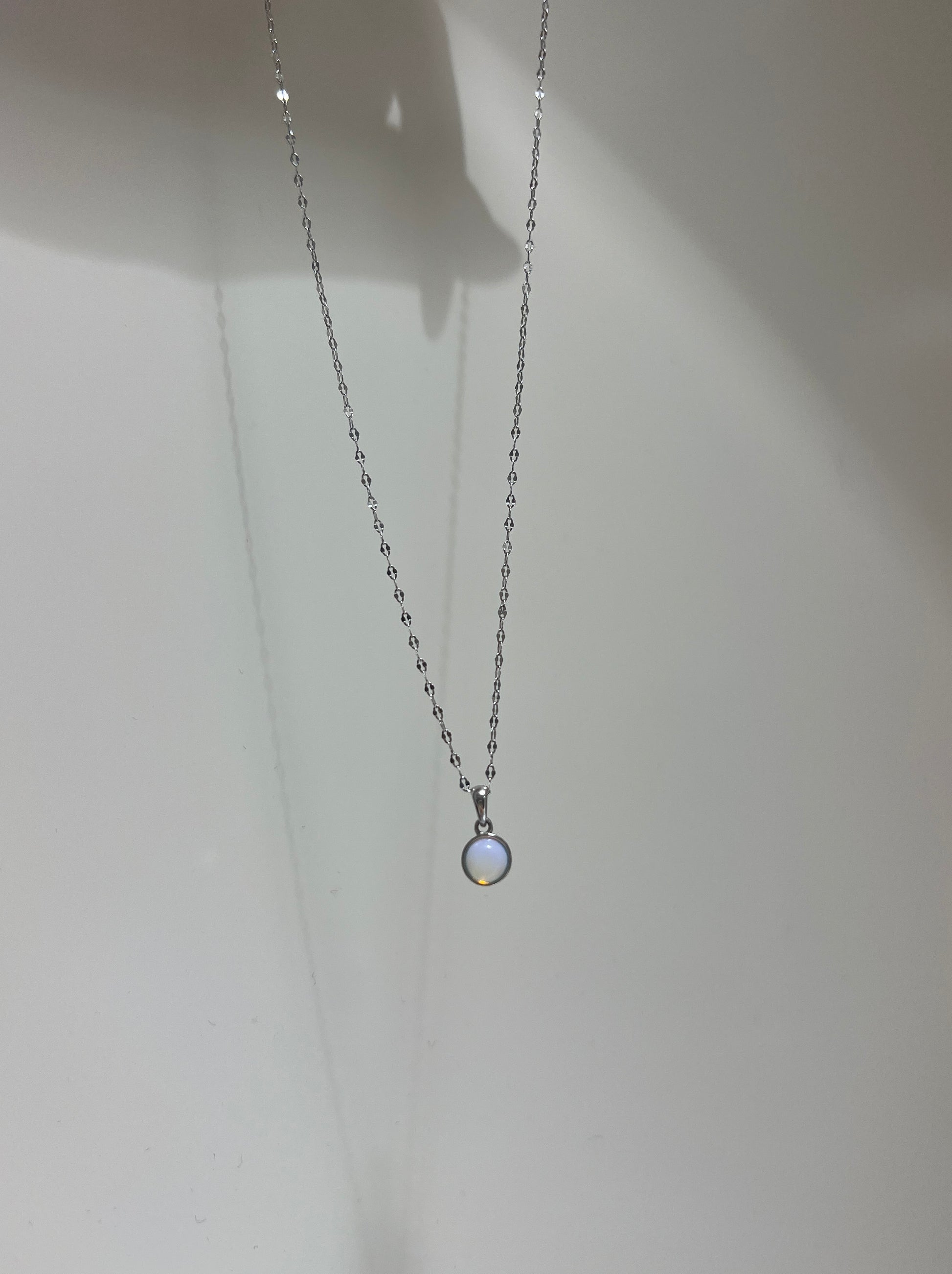 Necklace with a small pendant on a plain background
