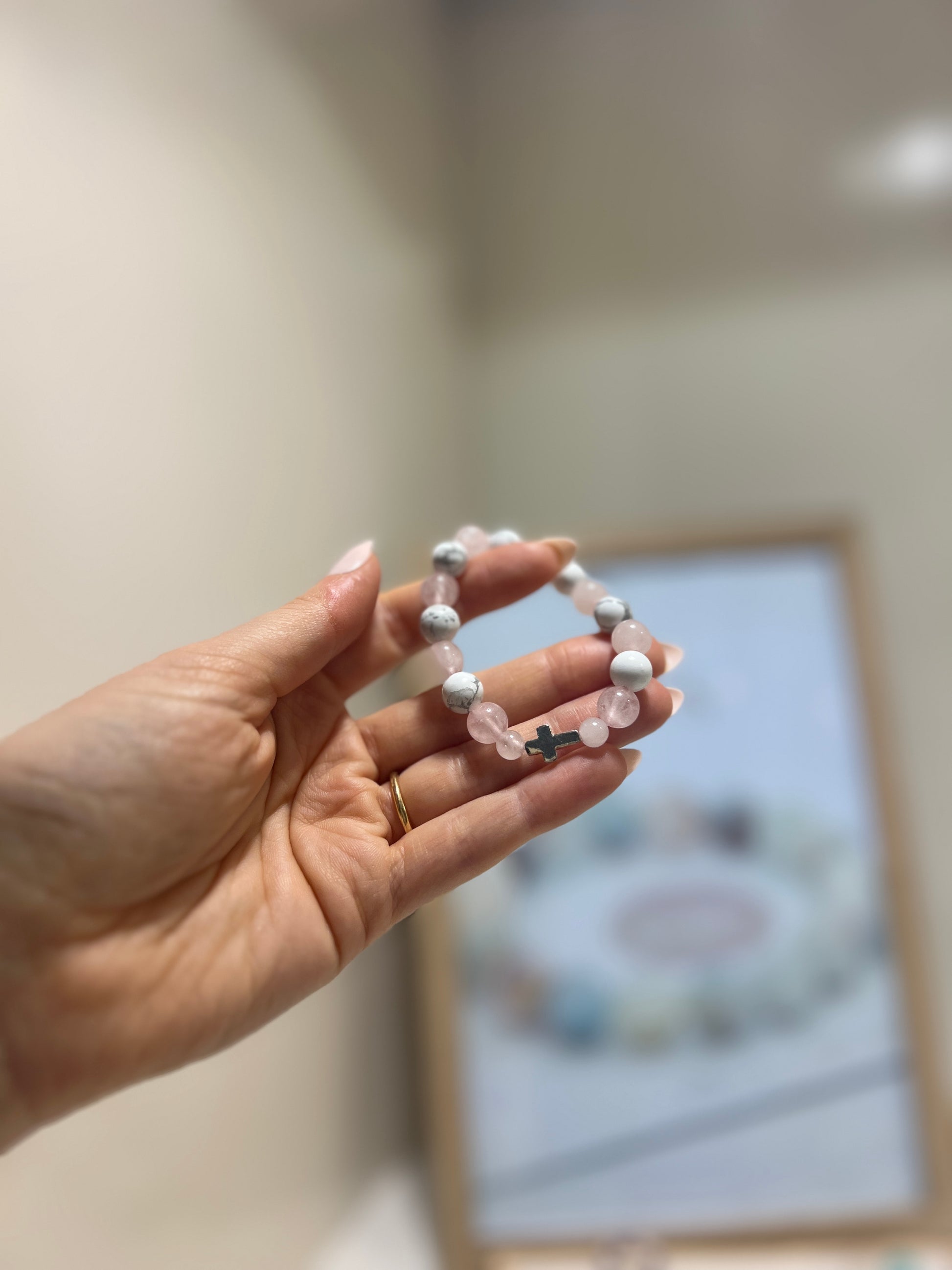 Hand holding a bracelet with a blurred background