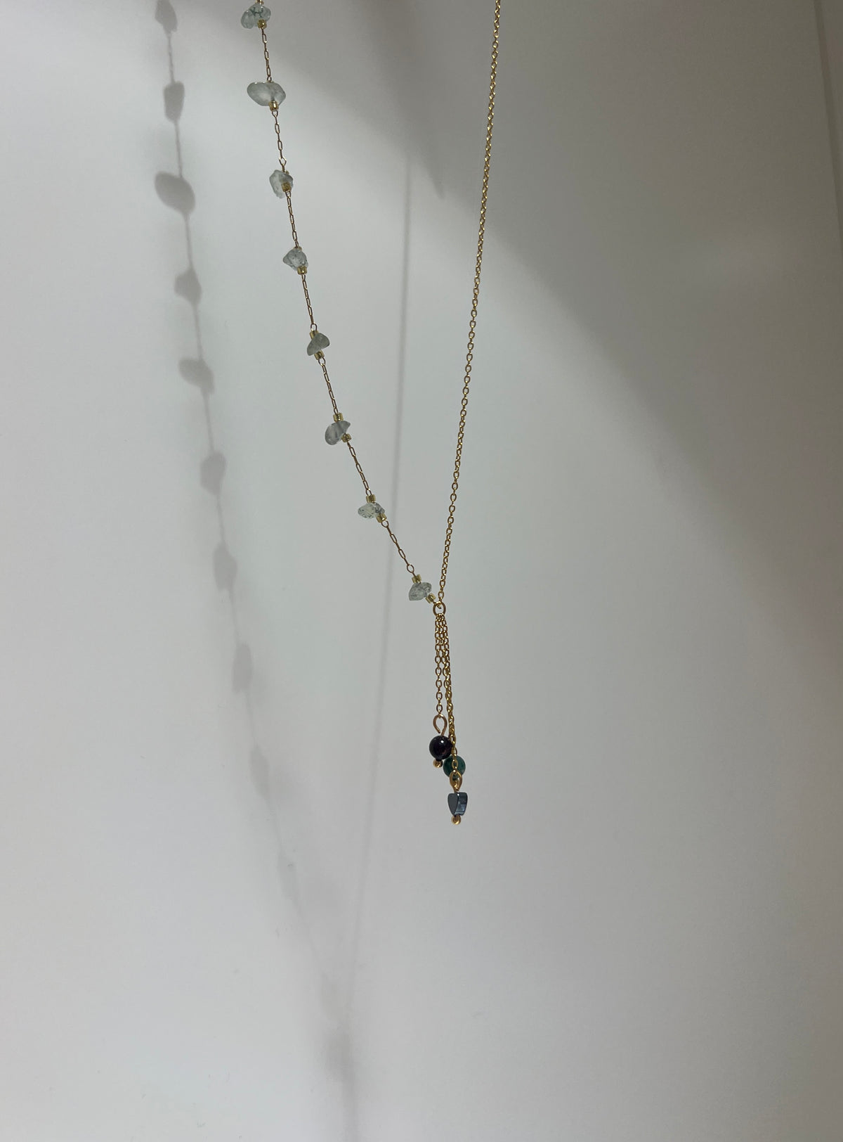 Necklace with small beads on a plain background